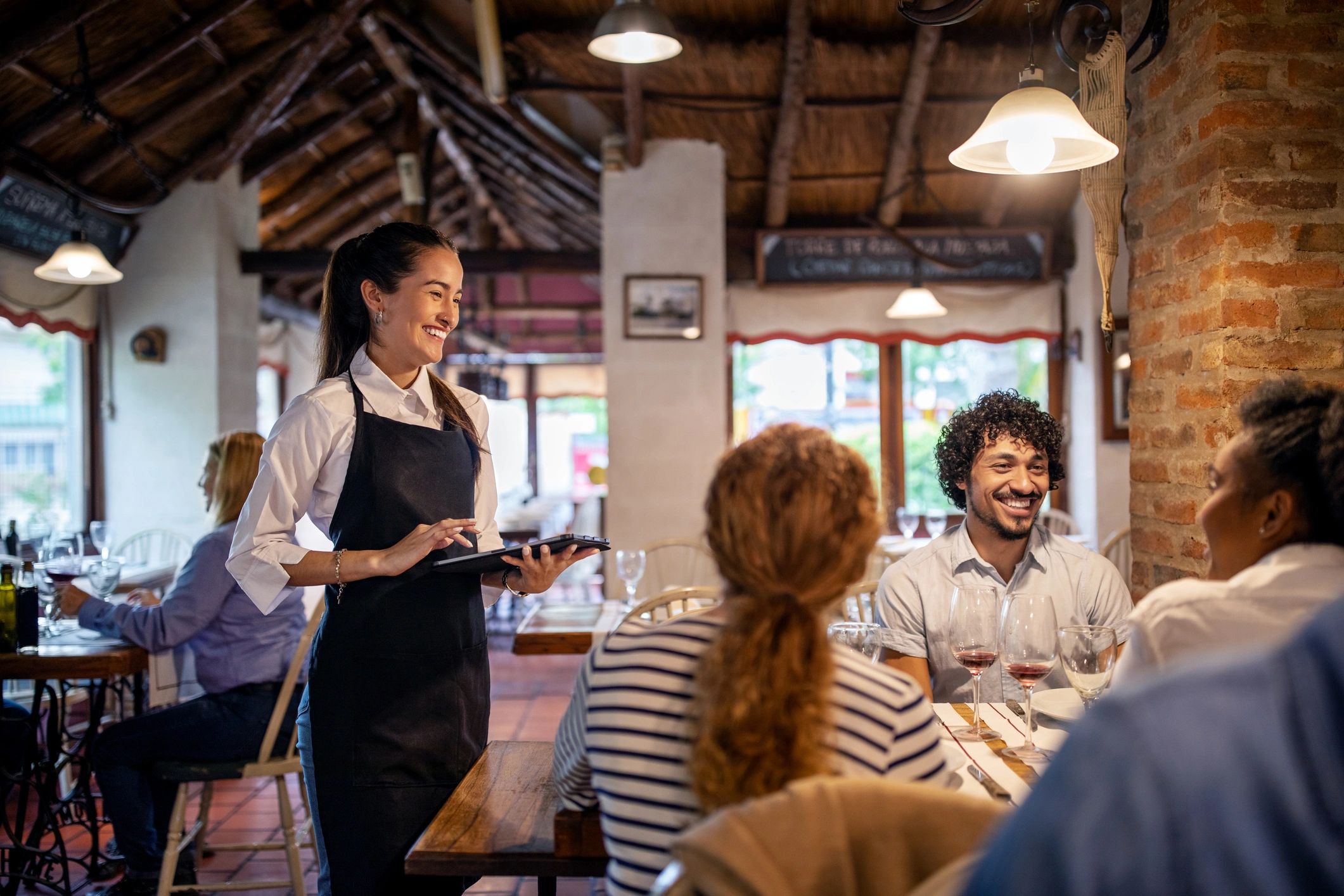 Italian restaurant staff serving guests